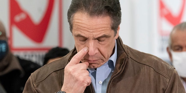 New York Gov. Andrew Cuomo touches his nose during a visit to a new COVID-19 vaccination site, Monday, March 15, 2021, at the State University of New York in Old Westbury. (AP Photo/Mark Lennihan, Pool)