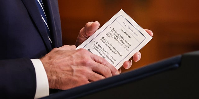 U.S. President Joe Biden holds notes on infrastructure while speaking during a news conference in the East Room of the White House in Washington, D.C., U.S., on Thursday, March 25, 2021. Biden's first formal news conference is a high-stakes test for a president facing questions about two recent mass shootings, a surge in migrant children at the U.S. southern border and the ongoing pandemic. Photographer: Oliver Contreras/Sipa/Bloomberg via Getty Images