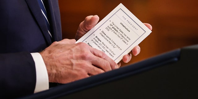 U.S. President Joe Biden holds notes on infrastructure while speaking during a news conference in the East Room of the White House in Washington, D.C., U.S., on Thursday, March 25, 2021. Biden's first formal news conference is a high-stakes test for a president facing questions about two recent mass shootings, a surge in migrant children at the U.S. southern border and the ongoing pandemic. Photographer: Oliver Contreras/Sipa/Bloomberg via Getty Images