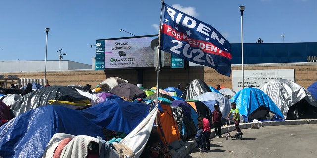 A Biden campaign flag at a migrants camp where asylum seekers wait for U.S. authorities to allow them to start their migration process outside El Chaparral crossing port in Tijuana, Baja California state, Mexico on March 21, 2021.
