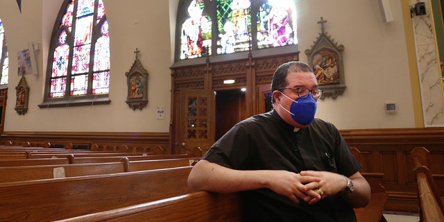 Reverend Manuel Rodriguez sits on the pews of his church, Our Lady of Sorrows, on Friday, March 5, 2021, in New York's Queens neighborhood.  (AP Photo / Jessie Wardarski)