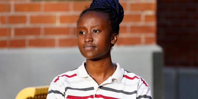 Peniella Irakoze sits on campus during a break from her part-time job at Phoenix College Thursday, Jan. 28, 2021 in Phoenix. (AP Photo/Matt York)