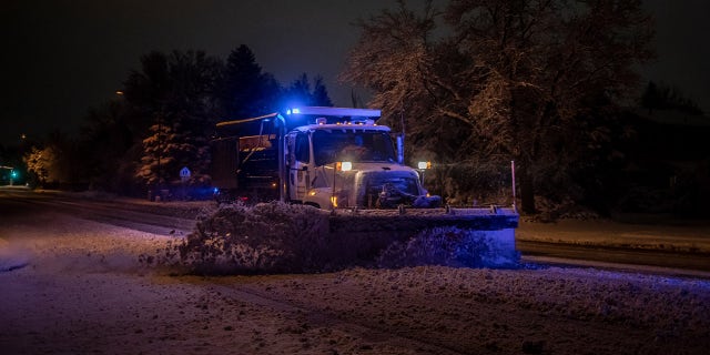 A snowplow clears streets of heavy snow during a winter storm in Boulder, Colorado, U.S., on Saturday, March 13, 2021. Photographer: Chet Strange/Bloomberg via Getty Images