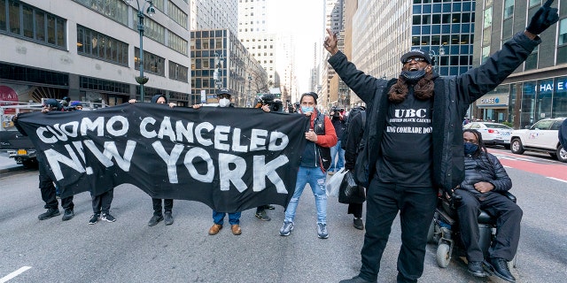 (Activist with VOCAL-NY block traffic on 3rd Ave. outside New York Gov. Andrew Cuomo's office, Wednesday, March 10, 2021, in New York. AP Photo/Mary Altaffer)