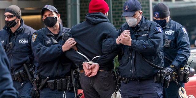 New York Police Officers arrest activists with VOCAL-NY after they blocked traffic on 3rd Ave. outside New York Gov. Andrew Cuomo's office, Wednesday, March 10, 2021, in New York. AP Photo/Mary Altaffer)