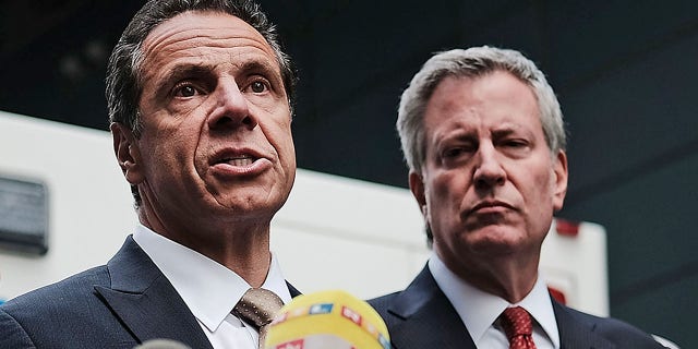 Governor of New York Andrew Cuomo stands with New York City Mayor Bill de Blasio(R) at a news conference at the Time Warner Center in 2018 in New York City. (Photo by Spencer Platt/Getty Images)