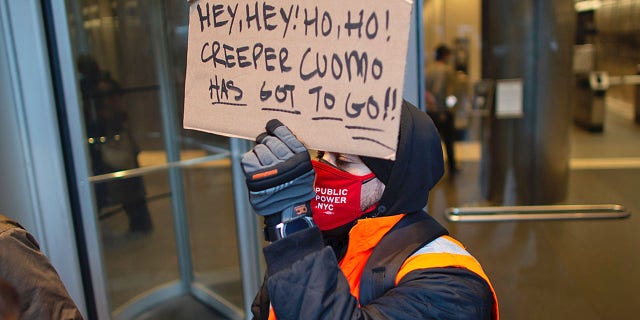 People attend a protest to demand New York Governor Andrew Cuomo's resignation after a third woman accused him of sexual harassment in New York City on March 2, 2021. - New York Governor Andrew Cuomo was fighting for his political life on March 2, 2021, after a third woman accused him of sexual harassment. The Democrat has suffered a spectacular fall from grace since he became a national star last year for his handling of the state's coronavirus pandemic. (Photo by Kena Betancur / AFP) (Photo by KENA BETANCUR/Afp/AFP via Getty Images)