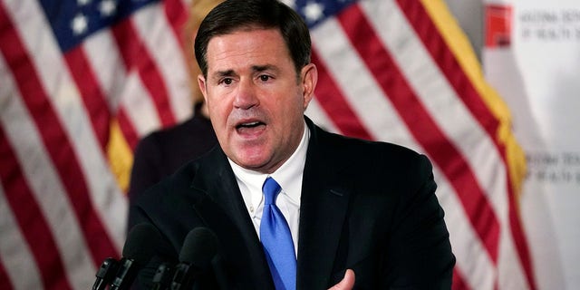 Arizona Republican Gov. Doug Ducey answers a question during a news conference in Phoenix.