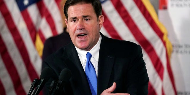 Arizona Republican Gov. Doug Ducey answers a question during a news conference in Phoenix.