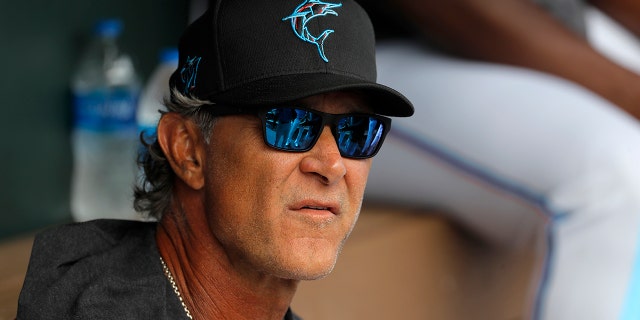 Miami Marlins manager Don Mattingly looks on from the dugout prior to a spring training baseball game against the Washington Nationals in Jupiter, Fla., in this Tuesday, March 10, 2020, photo. (AP Photo/Julio Cortez, File)