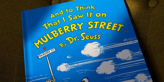 A copy of the book "And to Think That I Saw It on Mulberry Street," by Dr. Seuss, rests in a chair, Monday, March 1, 2021, in Walpole, Mass. (AP Photo/Steven Senne)