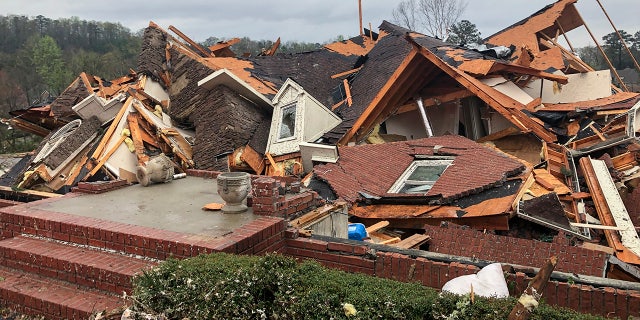 Damage is seen to a home after a tornado passed through the Eagle Point subdivision, Thursday, March 25, 2021, near Birmingham, Ala. Authorities reported major tornado damage Thursday south of Birmingham as strong storms moved through the state. The governor issued an emergency declaration as meteorologists warned that more twisters were likely on their way. (AP Photo/Butch Dill)