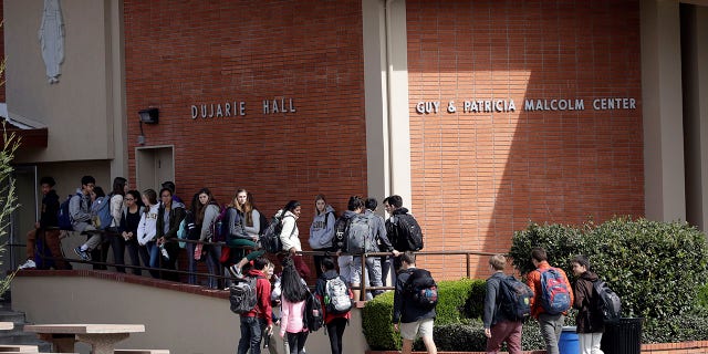 Students walk between buildings at St. Francis High School in Mountain View, California.