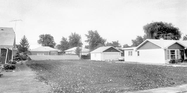 A barren plot of land is an uncomfortable reminder of the "house of horrors" home of John Wayne Gacy that once stood there. Prosecutors say he lured 33 young men to his home and killed them, burying 29 in a crawlspace. After weeks of excavation in search of the bodies, the home was demolished.