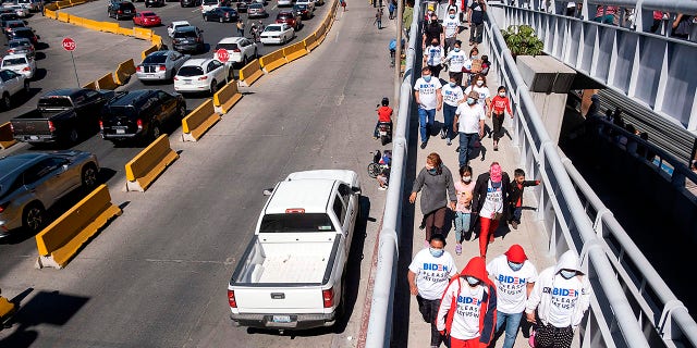 Migrants hold a demonstration demanding clearer United States migration policies at San Ysidro crossing port in Tijuana, Baja California state, Mexico, on March 2, 2021. (GUILLERMO ARIAS/AFP via Getty Images)