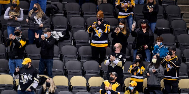 PITTSBURGH, PA - MARCH 02: Social distant fans cheer during the first period in the NHL game between the Pittsburgh Penguins and the Philadelphia Flyers on March 2, 2021, at PPG Paints Arena in Pittsburgh, PA. (Photo by Jeanine Leech/Icon Sportswire via Getty Images)