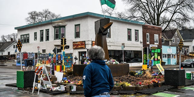 A man walks near the makeshift memorial of George Floyd before the third day of jury selection begins in the trial of former Minneapolis Police officer Derek Chauvin who is accused of killing Floyd, in Minneapolis, Minnesota on March 10, 2021. (Photo by CHANDAN KHANNA/AFP via Getty Images)