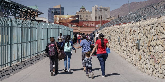Migrants who had been in Mexico under the Migrant Protection Protocols, or the "Remain in Mexico" program, enter the United States at the Paso del Norte Bridge in El Paso, Texas on March 10, 2021. (Photo by Paul Ratje / AFP) (Photo by PAUL RATJE/AFP via Getty Images)