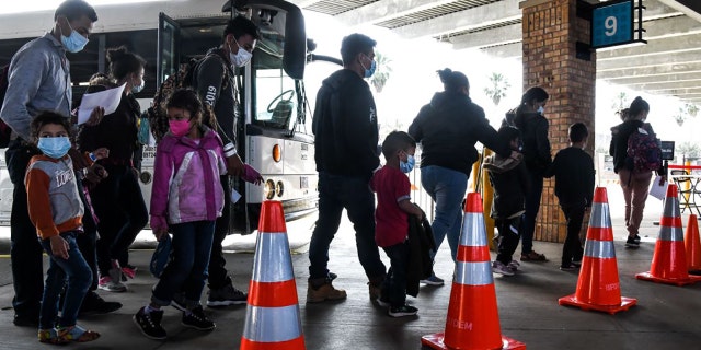Migrants mostly from Central America are dropped off by the US Customs and Border Protection at a bus station near the Gateway International Bridge, between the cities of Brownsville, Texas, and Matamoros, Mexico, on March 15, 2021, in Brownsville, Texas. (Photo by CHANDAN KHANNA / AFP) (Photo by CHANDAN KHANNA/AFP via Getty Images)