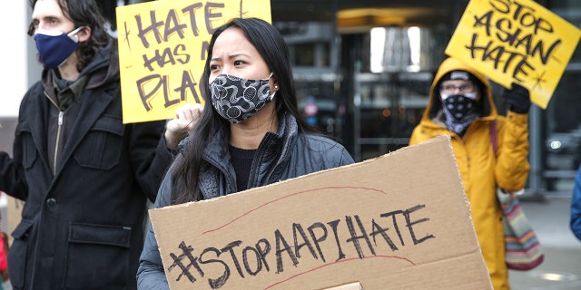 Protester holds a sign with the hashtag "stop AAPI hate" during the We Are Not Silent rally organized by the Asian American Pacific Islander (AAPI) Coalition Against Hate and Bias.