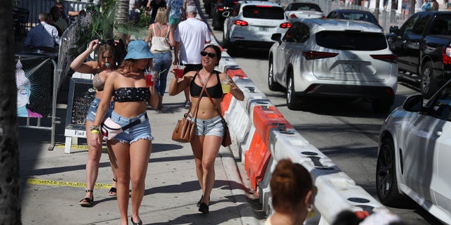 FORT LAUDERDALE, FLORIDA - MARCH 04: People walk near the beach on March 04, 2021 in Fort Lauderdale, Florida. College students have begun to arrive in the South Florida area for the annual spring break ritual. City officials are anticipating a large spring break crowd as the coronavirus pandemic continues. They are advising people to wear masks if they cannot social distance. (Photo by Joe Raedle/Getty Images)