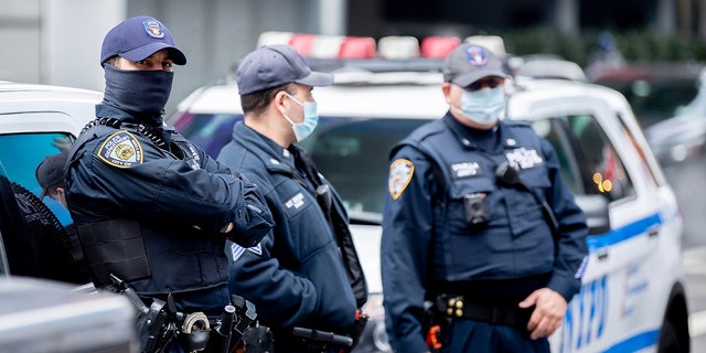 NYPD officers wear masks in Times Square. 