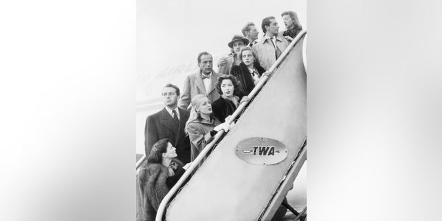 A group of Hollywood stars, representing 500 of their colleagues, leaving Los Angeles for Washington to protest the manner in which Washington's Investigation of Un-American Activities is being conducted. They are left to right, front row: Geraldine Brooks, June Havoc, Marsha Hunt, Lauren Bacall, Richard Conte, and Evelyn Keyes. Left to right, back row: Paul Henreid, Humphrey Bogart, (spokesman for the group), Gene Kelly and Danny Kaye.