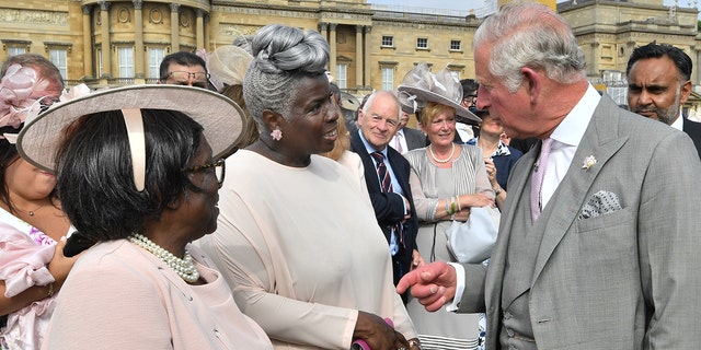 Prince Charles meets Kingdom Choir conductor Karen Gibson, center, and her mother as they attend a Buckingham Palace Garden Party on June 5, 2018 in London.  (Getty Images)