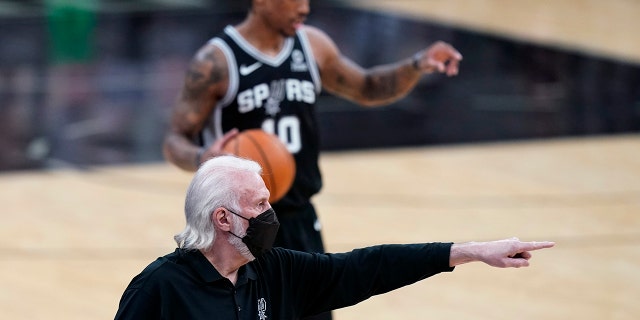 San Antonio Spurs coach Gregg Popovich directs players during the first half of an NBA basketball game against the New Orleans Pelicans in San Antonio, Saturday, Feb. 27, 2021.