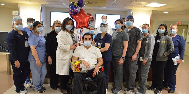 Alfredo Hercules is pictured with various staff who helped care for him during his months-long stay.