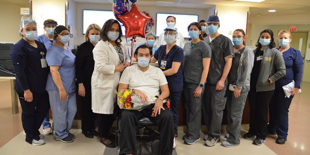 Alfredo Hercules is pictured with various staff who helped care for him during his months-long stay.