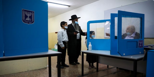 An Ultra-Orthodox Jewish man arrives to vote for Israel's parliamentary election at a polling station in Bnei Brak, Israel, on Tuesday. (AP)
