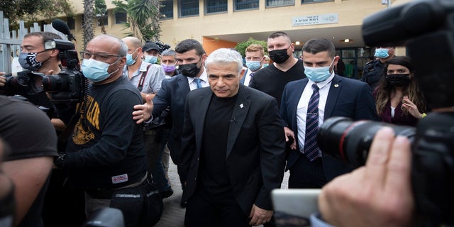 Yesh Atid party leader Yair Lapid leaves after he voted for Israel's parliamentary election at a polling station in Tel Aviv, Israel, on Tuesday. (AP)