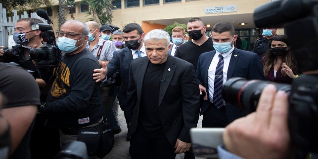 Yesh Atid party leader Yair Lapid leaves after he voted for Israel's parliamentary election at a polling station in Tel Aviv, Israel, on Tuesday. (AP)