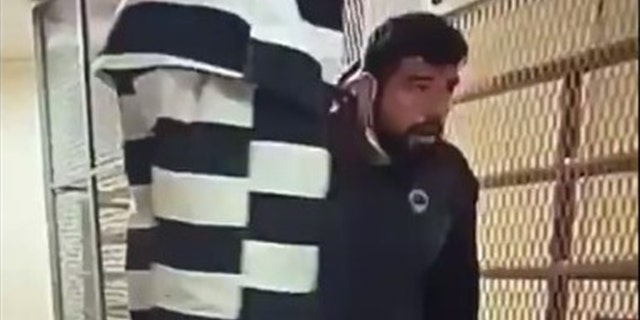 Daniel Misquez kneels as inmates at the Oklahoma County Detention Center in Oklahoma City take him hostage Saturday. He was beaten and stabbed multiple times during the chaos, authorities said.
