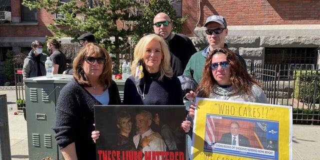 Janice Dean with sister-in-law Donna, her husband Sean, her niece Danielle and Danielle’s boyfriend Chris at the "We Care" Memorial Wall in Brooklyn, N.Y. on March 21, 2021. Dean is holding an image of her in-laws with the words, "These Lives Mattered." (Courtesy of the author)