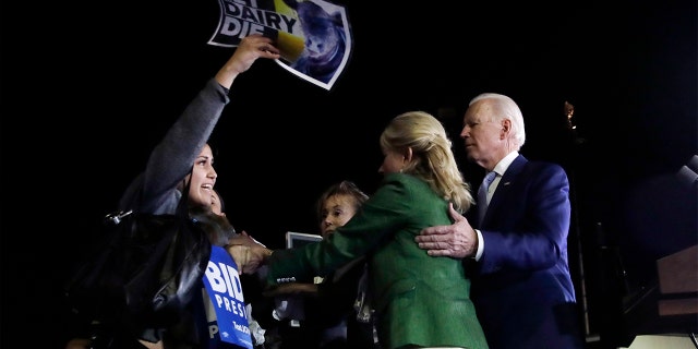 A protester at left, is held back by Jill Biden, center, and her husband, Democratic presidential candidate former Vice President Joe Biden, right, during a primary election night rally Tuesday, March 3, 2020, in Los Angeles. (AP Photo/Marcio Jose Sanchez)