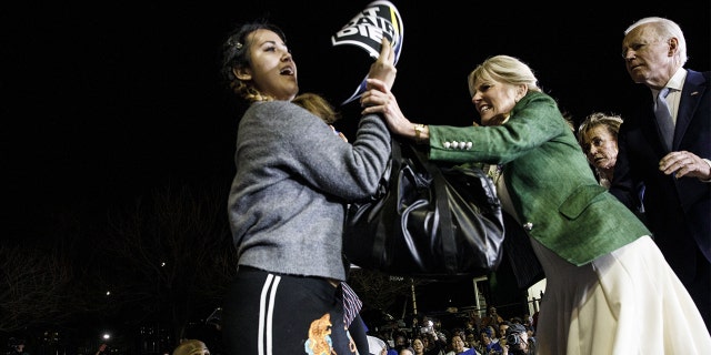 Bloomberg Best of the Year 2020: Former Vice President Joe Biden, 2020 Democratic presidential candidate, right, watches as his wife Jill Biden, center, blocks a protester from arriving on stage during an primary night rally in the Baldwin Hills neighborhood of Los Angeles, on Tuesday, March 3, 2020. Photographer: Patrick T. Fallon/Bloomberg via Getty Images