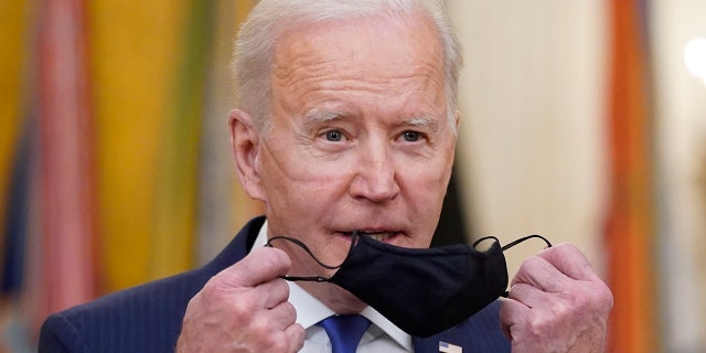 President Biden takes his face mask off before speaking during an event to mark International Women's Day, Monday, March 8, 2021, at White House.