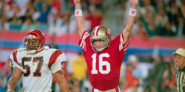 49ers quarterback Joe Montana raises his arms in celebration after throwing a touchdown pass to Jerry Rice.
