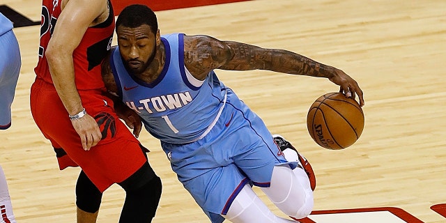Houston Rockets' John Wall (1) drives on Toronto Raptors' Fred VanVleet (23) during the third quarter of an NBA basketball game Monday, March 22, 2021, in Houston. (Bob Levey/Pool Photo via AP)