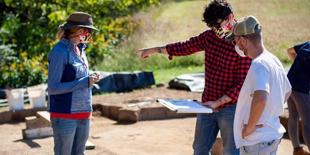 Historic St. Mary’s City archaeologists Stephanie Stevens and August Rowell consult with Director of Research and Collections Dr. Travis Parno (center) at the St. Mary’s Fort dig site (Credit: Historic St. Mary’s City)