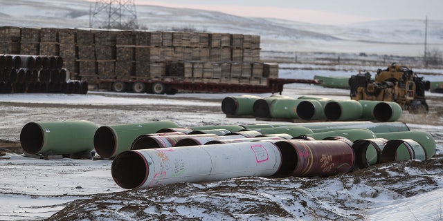 Pipes for the Keystone XL pipeline stacked in a yard near Oyen, Alberta, Canada, on Tuesday, Jan. 26, 2021. U.S. President Joe Biden revoked the permit for TC Energy Corp.'s Keystone XL energy pipeline via executive order hours after his inauguration, the clearest sign yet that constructing a major new pipeline in the U.S. has become an impossible task. Photographer: Jason Franson/Bloomberg via Getty Images