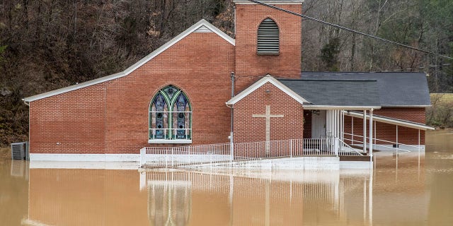 Flood waters surround Rockhouse Freewill Baptist Church in Johnson County, Ky., Monday, March 1, 2021. Heavy rain across Appalachia has led to water rescues, mudslides, road closures and power outages, officials said. (Ryan C. Hemens/Lexington Herald-Leader via AP)