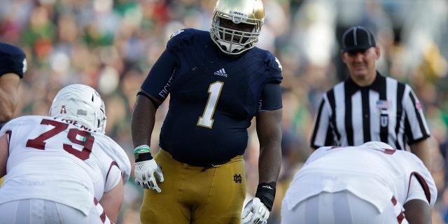 In this Saturday, Aug. 31, 2013, file photo, Notre Dame defensive lineman Louis Nix III (1) prepares to get into his defensive stance during the second half of an NCAA college football game against Temple in South Bend, Ind. (AP Photo/Michael Conroy, File)