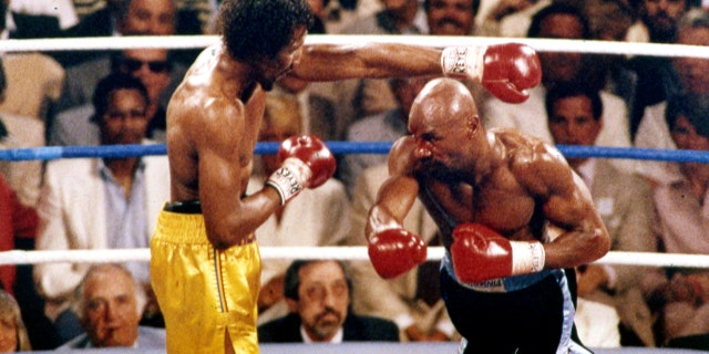 FILE - In this April 1985 file photo, Marvin Hagler, right, and Thomas Hearns fight during the first round of a world championship boxing bout in Las Vegas. Hagler, the middleweight boxing great whose title reign and career ended with a split-decision loss to "Sugar" Ray Leonard in 1987, died Saturday, March 13, 2021. He was 66. (AP Photo, File)