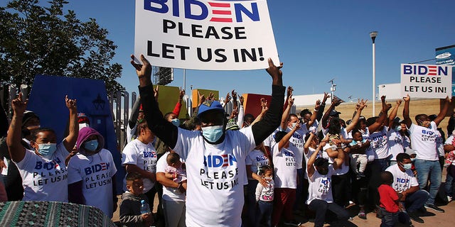 Mexico-migrants-Biden-sign.jpg