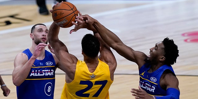 Utah Jazz guard Donovan Mitchell blocks a shot by Utah Jazz center Rudy Gobert during the second half of basketball's NBA All-Star Game in Atlanta, Sunday, March 7, 2021. (AP Photo/Brynn Anderson)