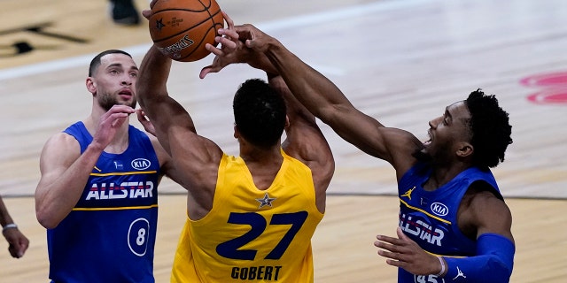 Utah Jazz guard Donovan Mitchell blocks a shot by Utah Jazz center Rudy Gobert during the second half of basketball's NBA All-Star Game in Atlanta, Sunday, March 7, 2021. (AP Photo/Brynn Anderson)