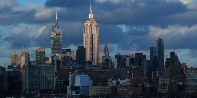 The sun sets on the Empire State Building, One Vanderbilt and the Chrysler Building in New York City on March 14, 2021, as seen from Jersey City, New Jersey. 